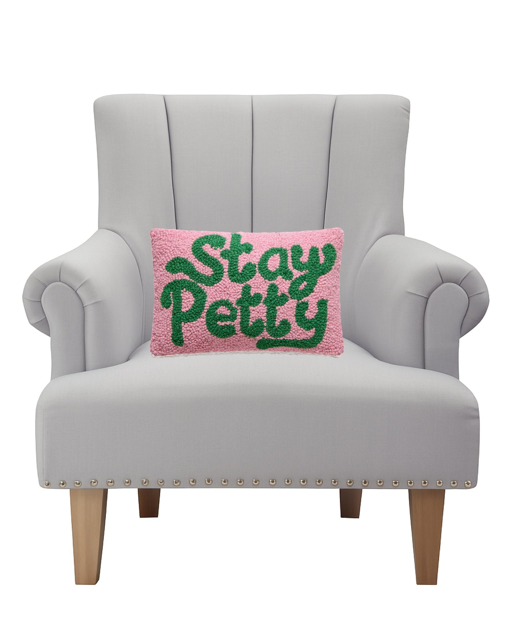 Stay Petty Hooked Wool Throw Pillow on an armchair, showing the throw pillow at room scale, 8x12 inch