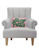 Stay Petty Hooked Wool Throw Pillow on an armchair, showing the throw pillow at room scale, 8x12 inch