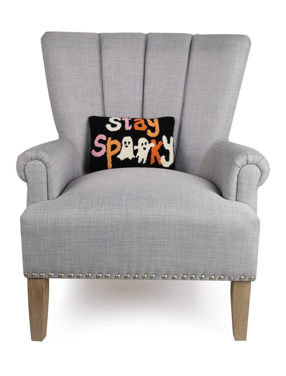 Stay Spooky Hooked Wool Halloween Throw Pillow on an armchair, showing the throw pillow at room scale, 8x12 inch