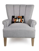 Stay Spooky Hooked Wool Halloween Throw Pillow on an armchair, showing the throw pillow at room scale, 8x12 inch