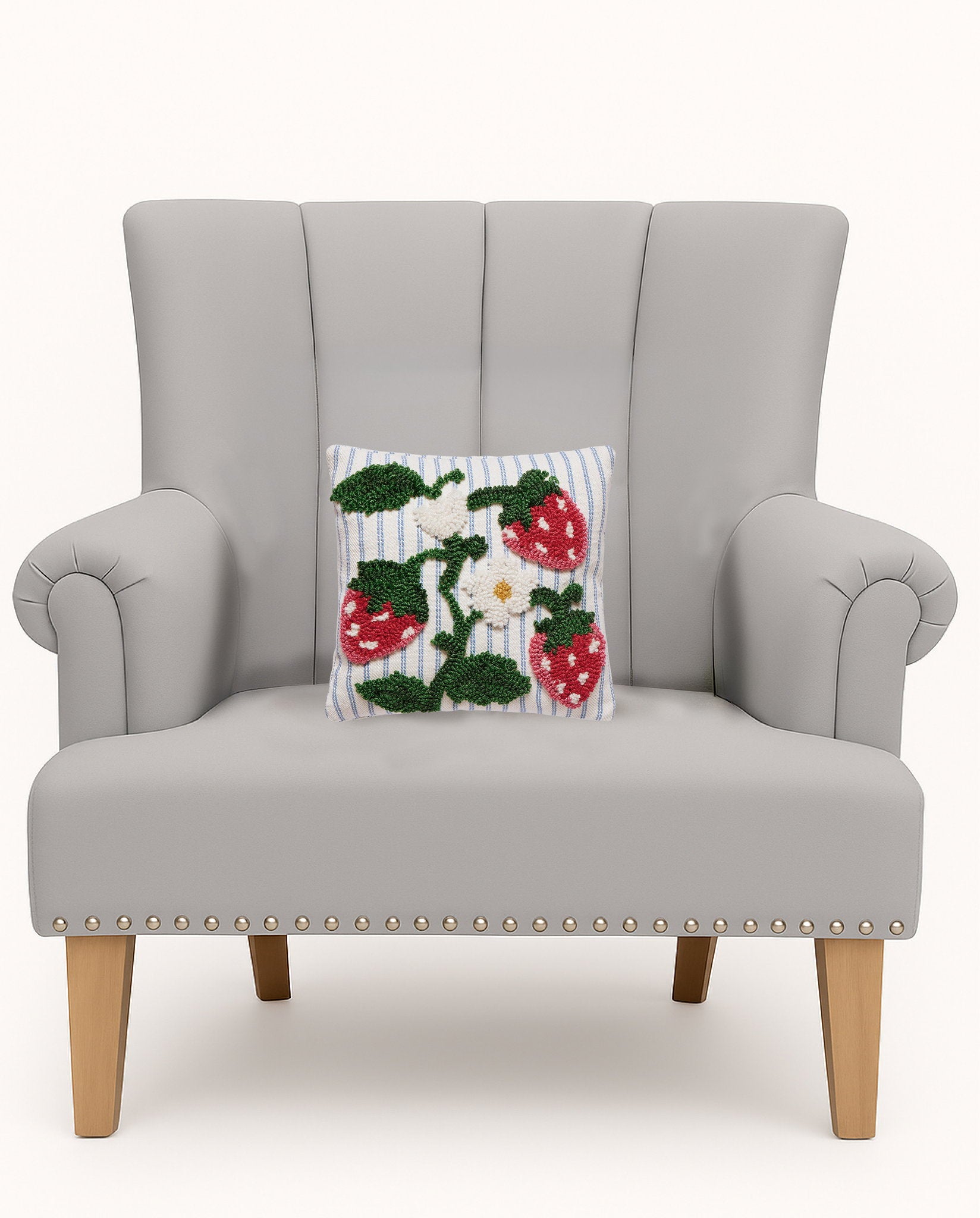 Strawberries Tufted Poly Hooked Throw Pillow on an armchair, showing the throw pillow at room scale, 10x10 inch