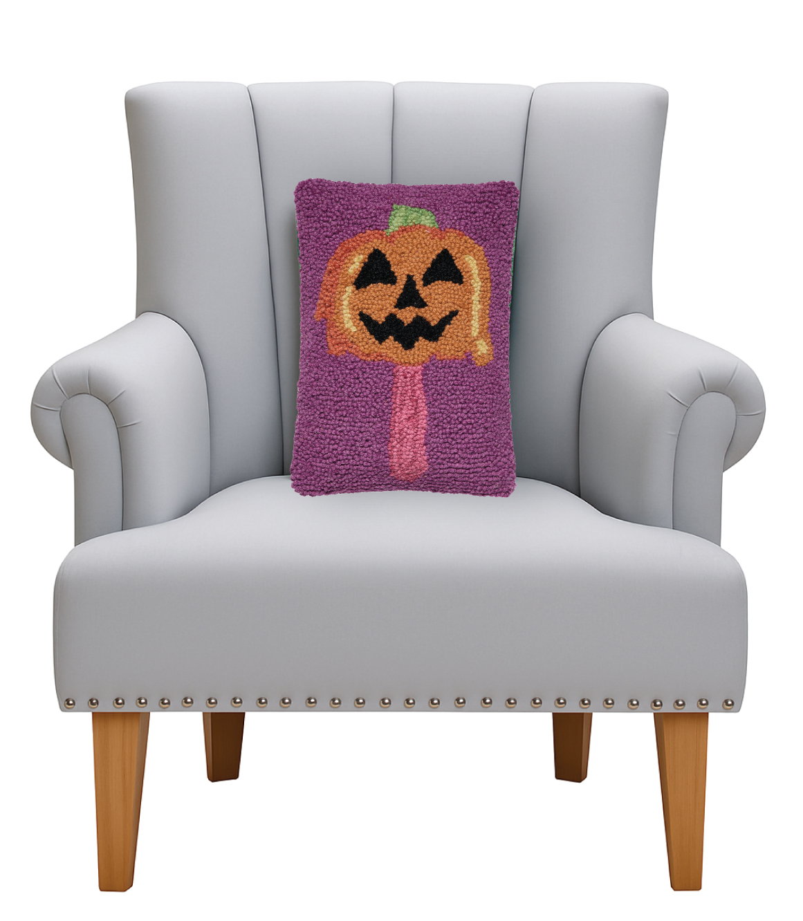 Summerween Jack Popsicle Hooked Wool Halloween Throw Pillow on an armchair, showing the throw pillow at room scale, 8x12 inch