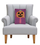 Summerween Jack Popsicle Hooked Wool Halloween Throw Pillow on an armchair, showing the throw pillow at room scale, 8x12 inch