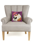 Summerween Skull Hooked Wool Halloween Throw Pillow on an armchair, showing the throw pillow at room scale, 10x10 inch