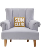 Sun Club Hooked Wool Throw Pillow on an armchair, showing the throw pillow at room scale, 10x10 inch
