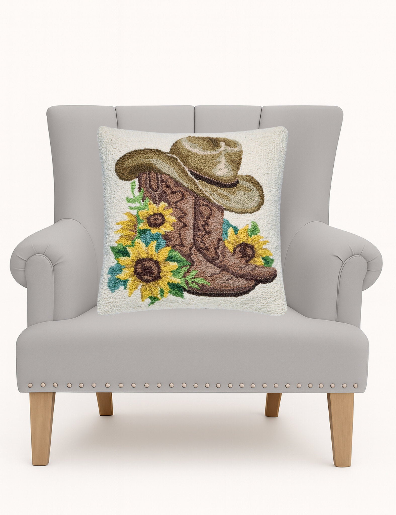 Sunflower Boots Hooked Wool Throw Pillow on an armchair, showing the throw pillow at room scale, 18x18 inch