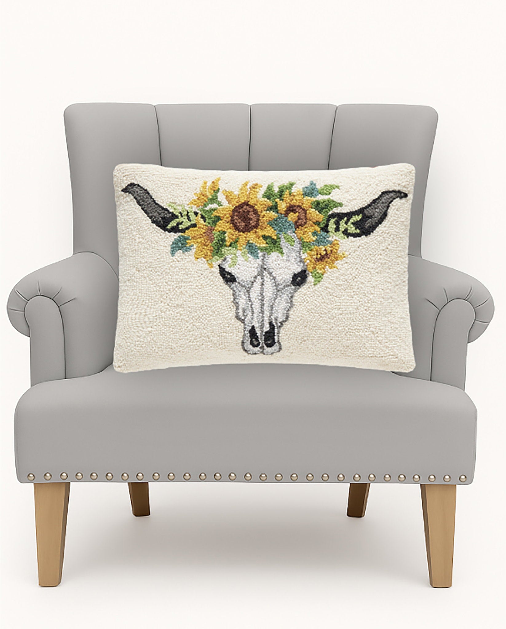 Sunflower Skull Hooked Wool Halloween Throw Pillow on an armchair, showing the throw pillow at room scale, 14x20 inch