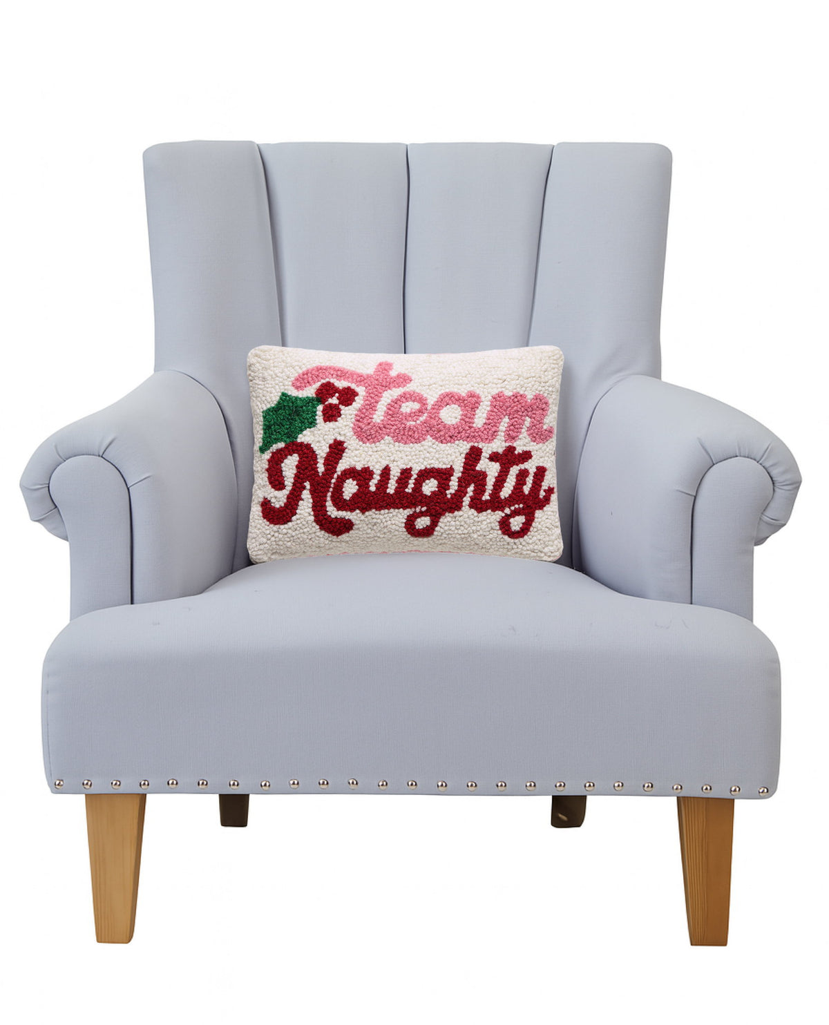 Team Naughty Hooked Wool Christmas Throw Pillow on an armchair, showing the throw pillow at room scale, 8x12 inch
