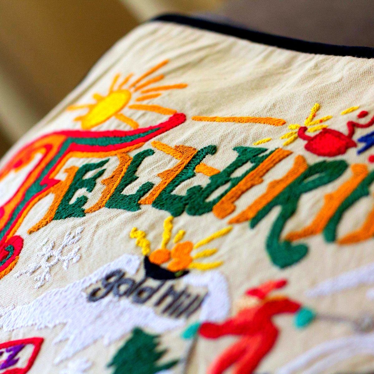 Telluride, CO Embroidered Ski Lodge Pillow - close-up detail of hand-embroidered needlepoint stitching
