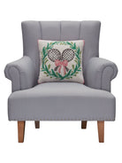 Tennis with Wreath Hooked Wool Throw Pillow on an armchair, showing the throw pillow at room scale, 16x16 inch