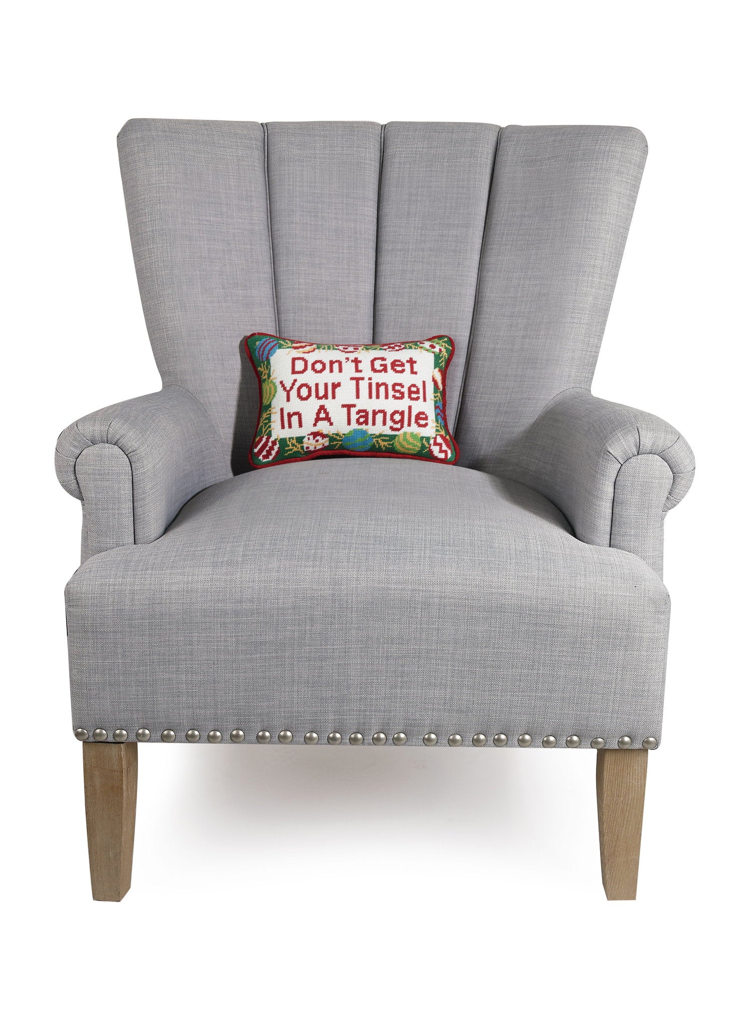 Tinsel Tangle Ebb Needlepoint Christmas Throw Pillow on an armchair, showing the throw pillow at room scale, 8x12 inch