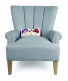 Toadstool Trio Mushrooms Hooked Wool Throw Pillow on an armchair, showing the throw pillow at room scale, 12x5 inch