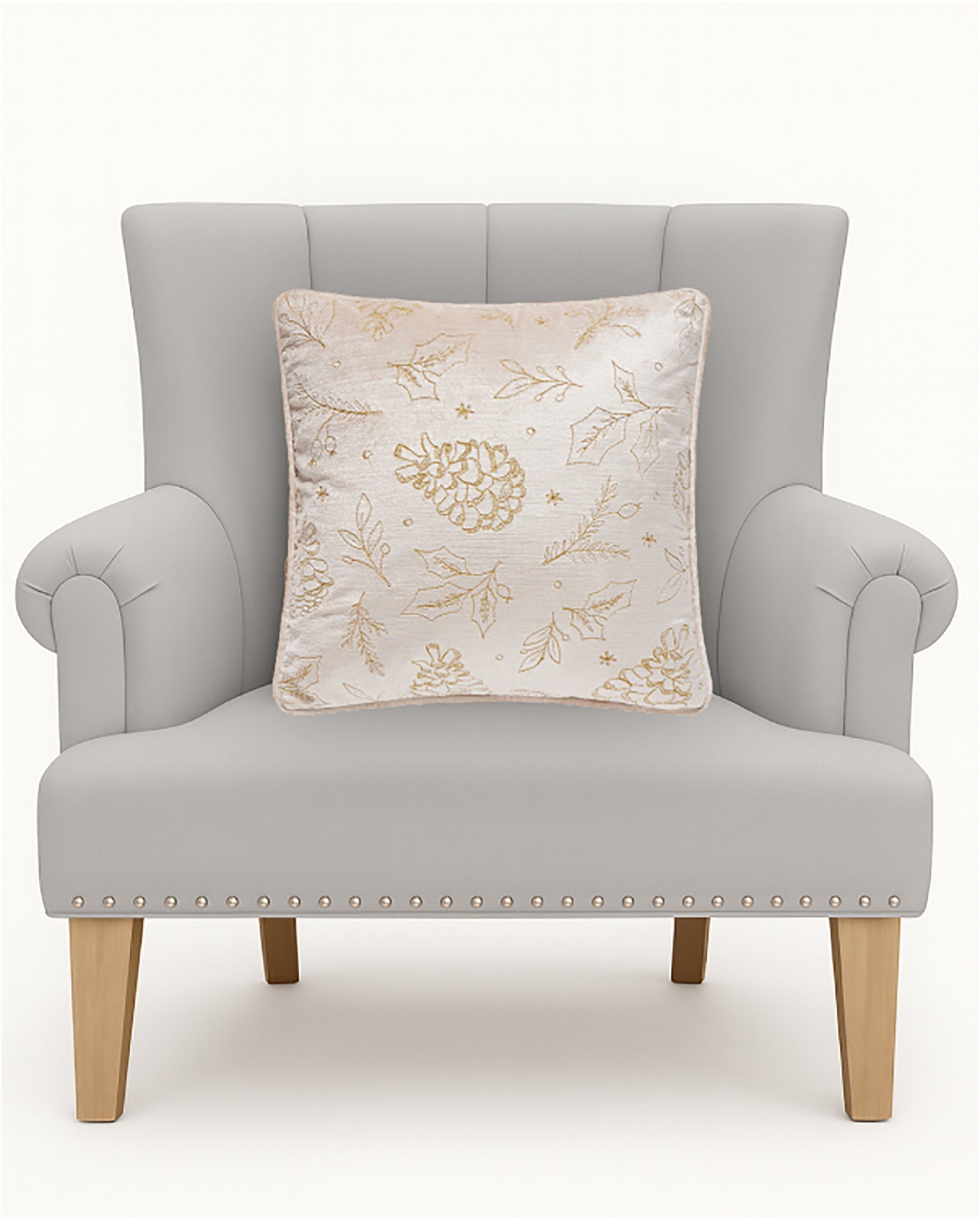 Tossed Foliage Champagne Velvet Embroidered Christmas Throw Pillow on an armchair, showing the throw pillow at room scale, 16x16 inch