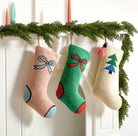 Tree with Tassel Hooked Wool Christmas Stocking shown alongside other designs in the same collection, 12x20 inch