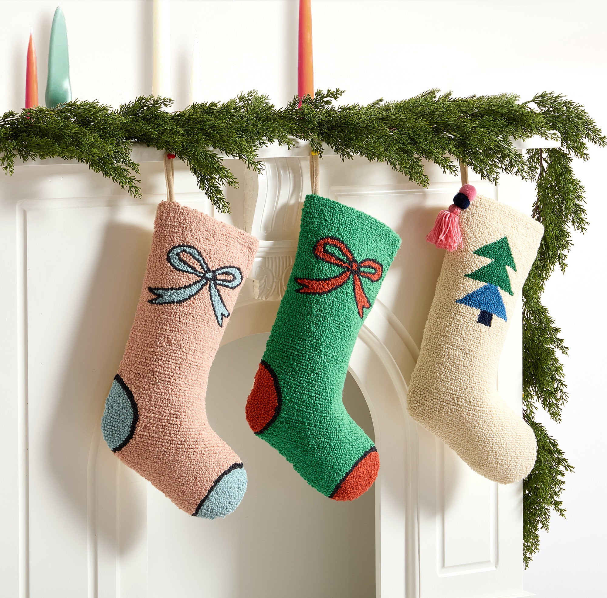Tree with Tassel Hooked Wool Christmas Stocking shown alongside other designs in the same collection, 12x20 inch