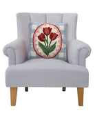Tulip Frame Hooked Wool Throw Pillow on an armchair, showing the throw pillow at room scale, 14x14 inch