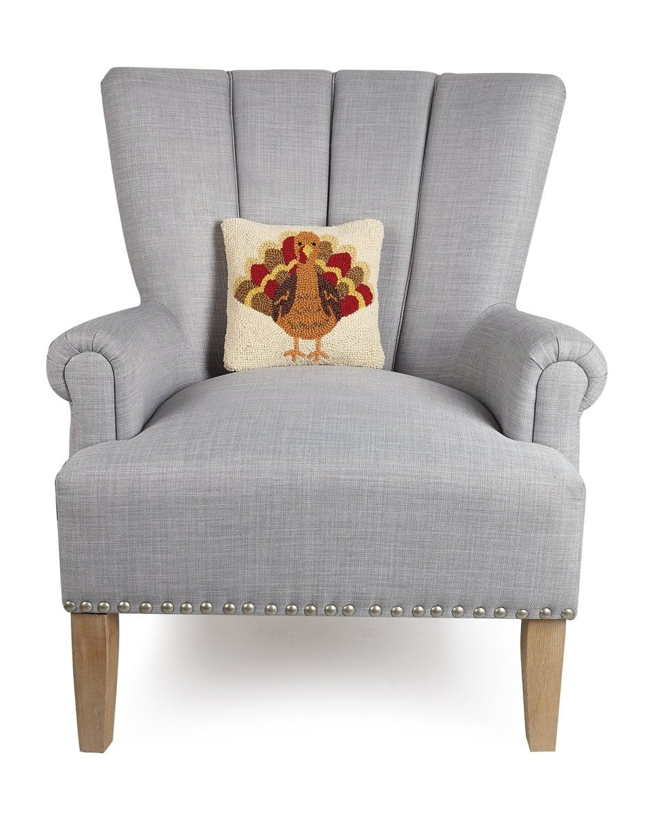 Turkey Hooked Wool Fall Harvest Throw Pillow on an armchair, showing the throw pillow at room scale, 10x10 inch