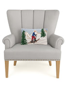 Uphill Skier Hooked Wool Christmas Throw Pillow on an armchair, showing the throw pillow at room scale, 8x12 inch