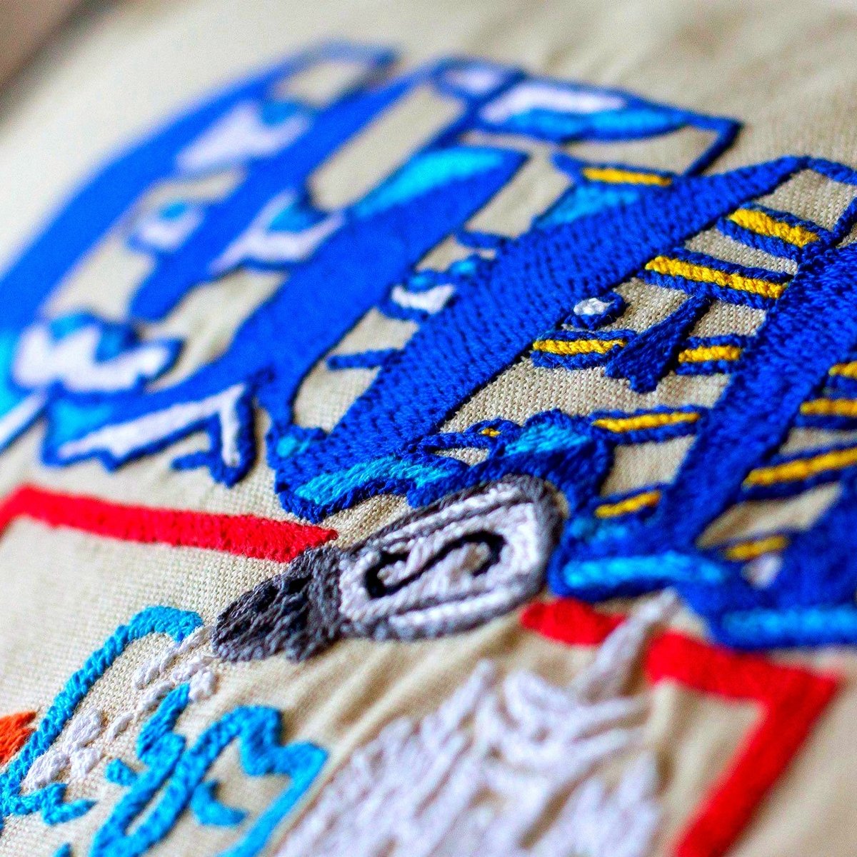 Utah State Beehive Travel Embroidered Throw Pillow - close-up detail of hand-embroidered needlepoint stitching