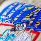 Utah State Beehive Travel Embroidered Throw Pillow - close-up detail of hand-embroidered needlepoint stitching