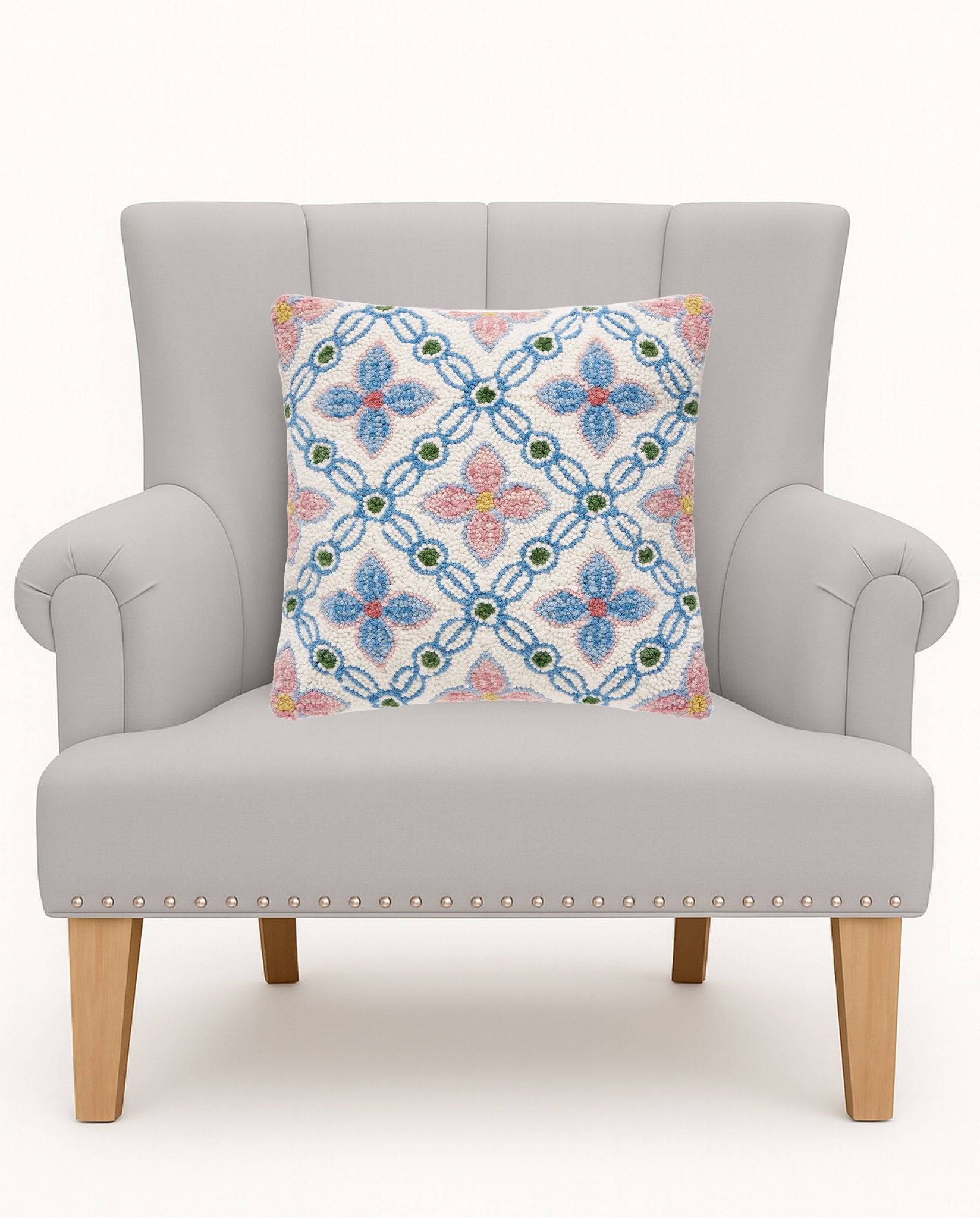 Vintage Floral Tile Hooked Wool Throw Pillow on an armchair, showing the throw pillow at room scale, 16x16 inch