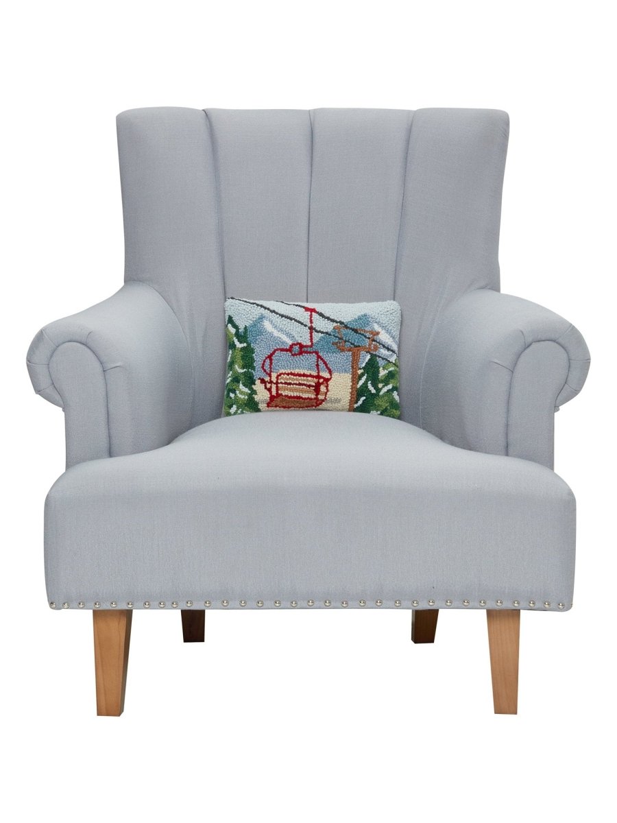 Vintage Gondola Hooked Wool Christmas Throw Pillow on an armchair, showing the throw pillow at room scale, 8x12 inch