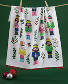 Vintage Nutcrackers with Pom Pom Printed Christmas Kitchen Towel styled in a room setting, 18x25 inch