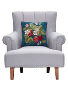 Vintage Strawberries Hooked Wool Throw Pillow on an armchair, showing the throw pillow at room scale, 16x16 inch