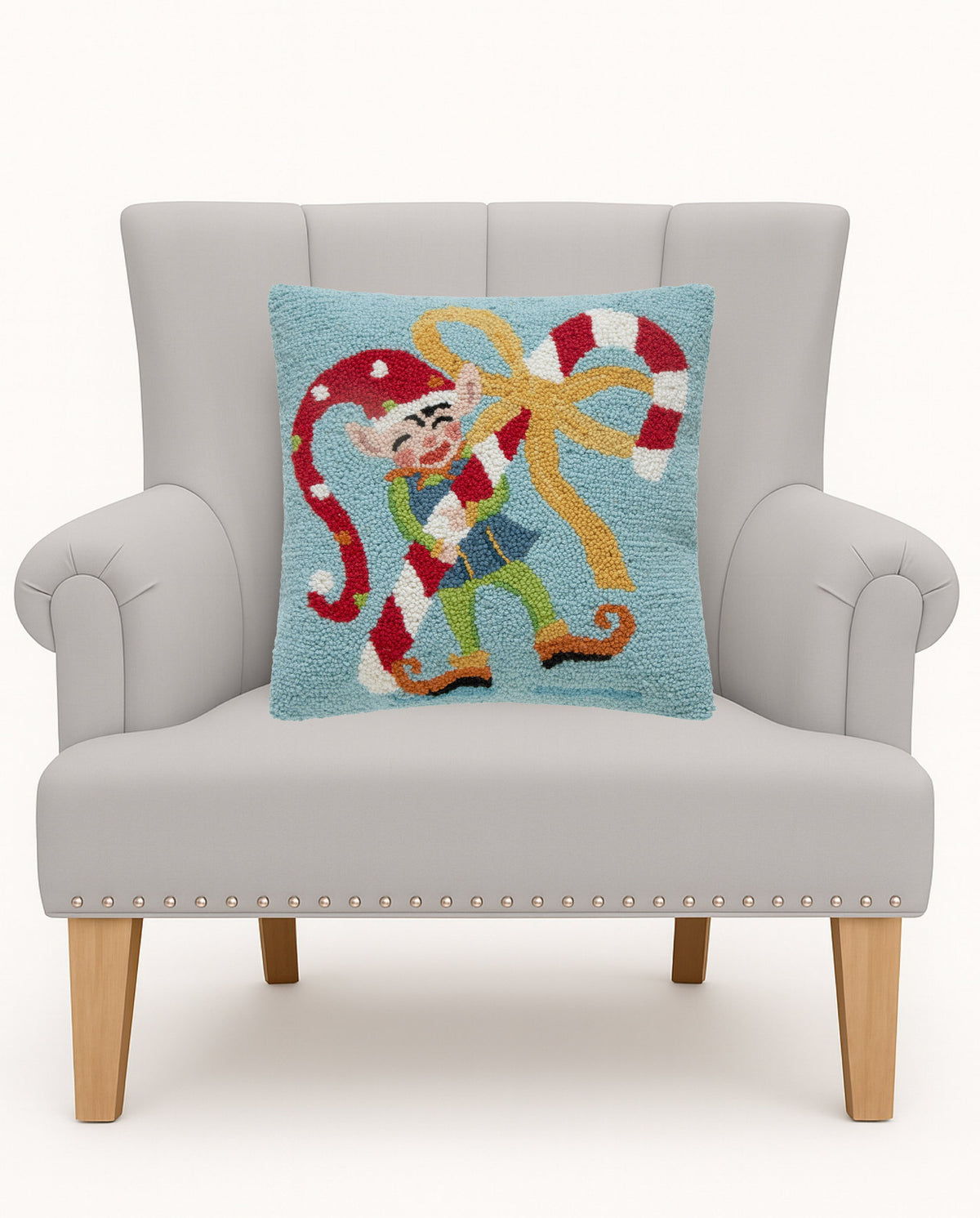 Whimsy Elf Hooked Wool Christmas Throw Pillow on an armchair, showing the throw pillow at room scale, 16x16 inch