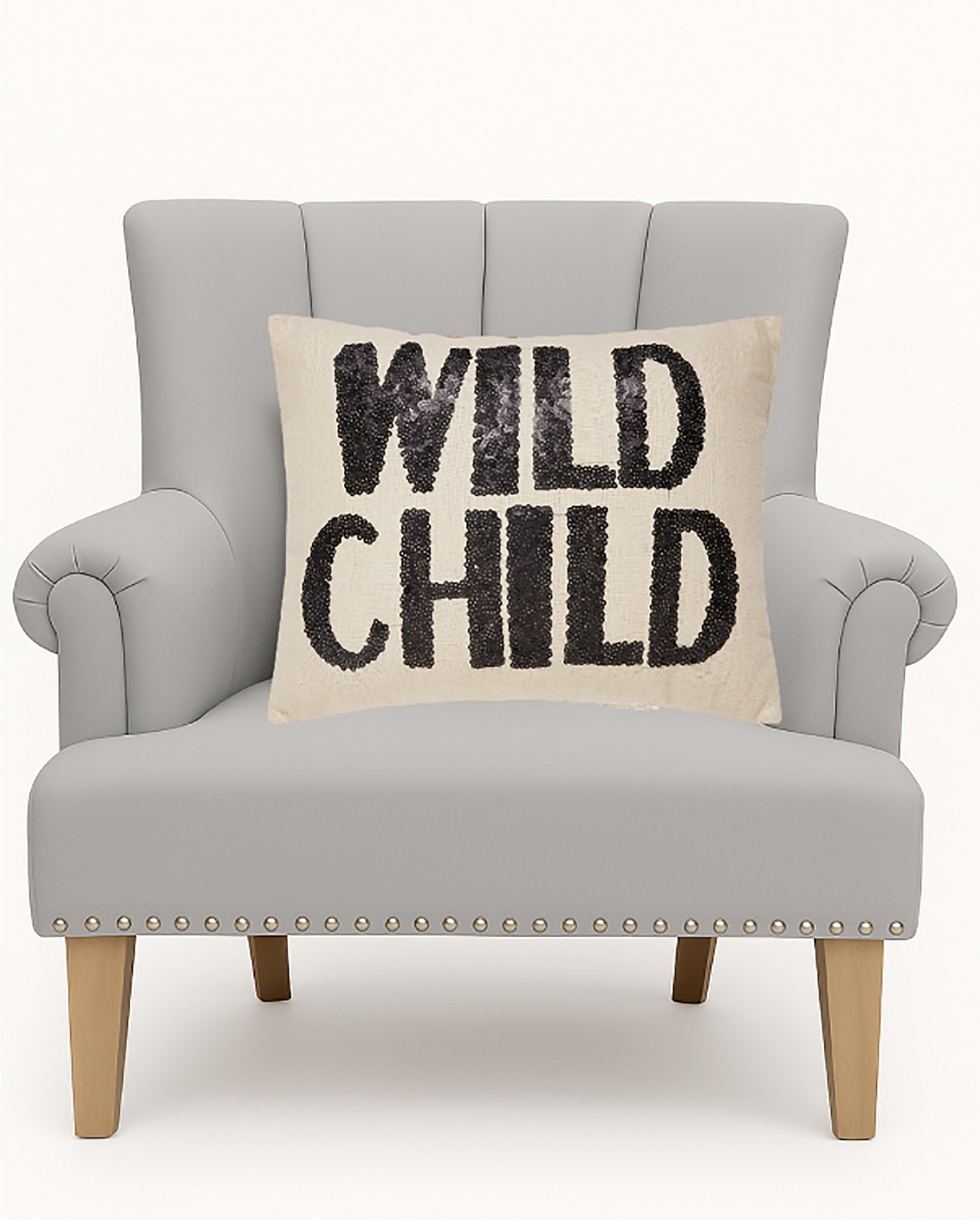 Wild Child Sequin Embroidered Throw Pillow on an armchair, showing the throw pillow at room scale, 14x18 inch