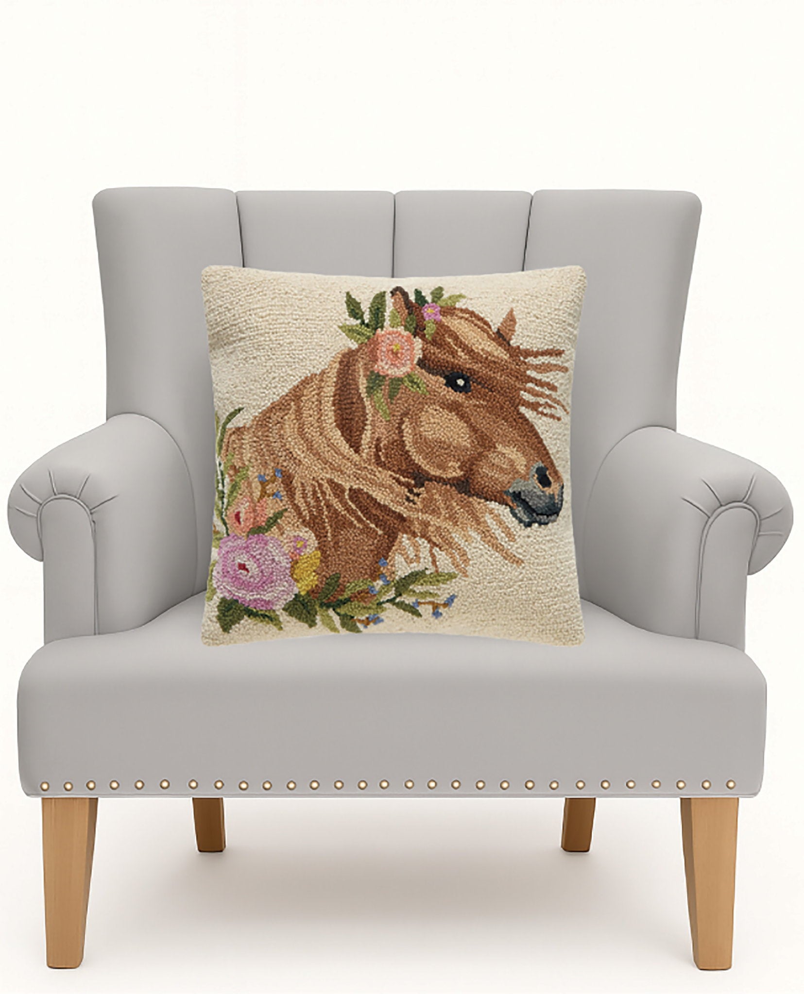 Windswept Horse Hooked Wool Throw Pillow on an armchair, showing the throw pillow at room scale, 18x18 inch