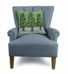 Winter Trees Hooked Wool Christmas Throw Pillow on an armchair, showing the throw pillow at room scale, 18x18 inch