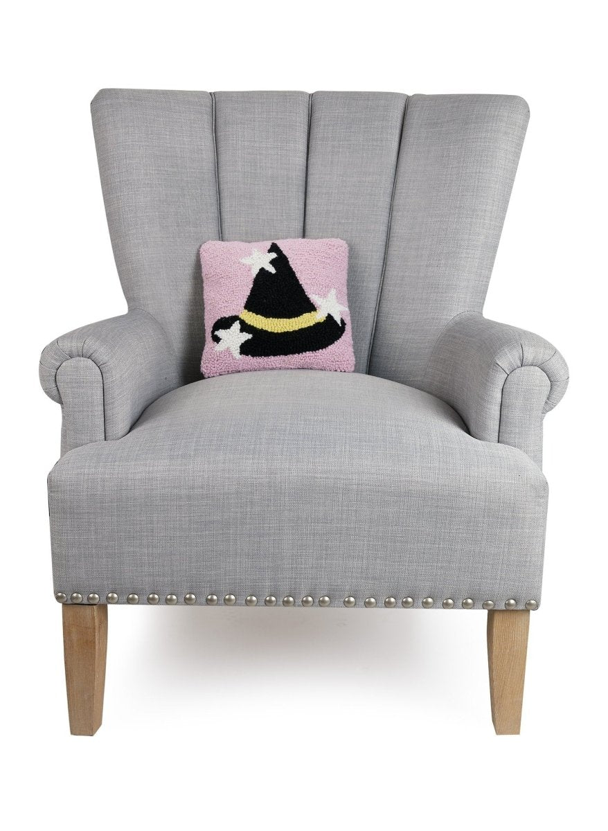 Witch Hat with Stars Hooked Wool Halloween Throw Pillow on an armchair, showing the throw pillow at room scale, 10x10 inch
