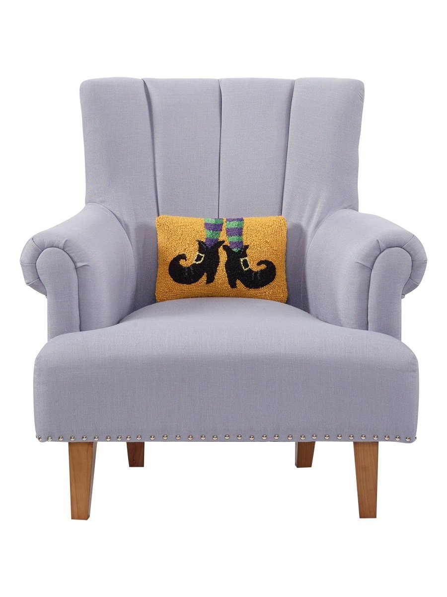 Witch Shoes Hooked Wool Halloween Throw Pillow on an armchair, showing the throw pillow at room scale, 8x12 inch