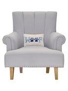 Woof Hooked Wool Throw Pillow on an armchair, showing the throw pillow at room scale, 8x12 inch