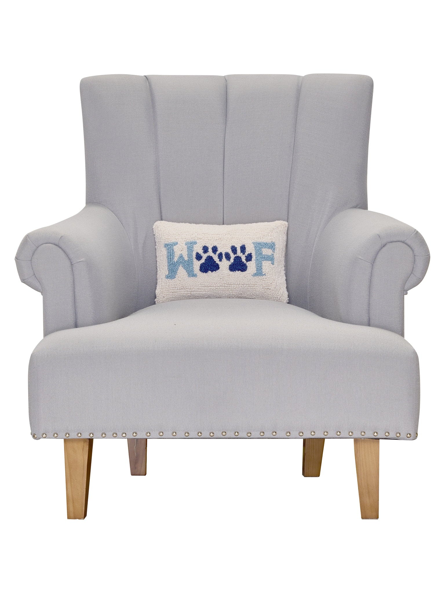 Woof Hooked Wool Throw Pillow on an armchair, showing the throw pillow at room scale, 8x12 inch