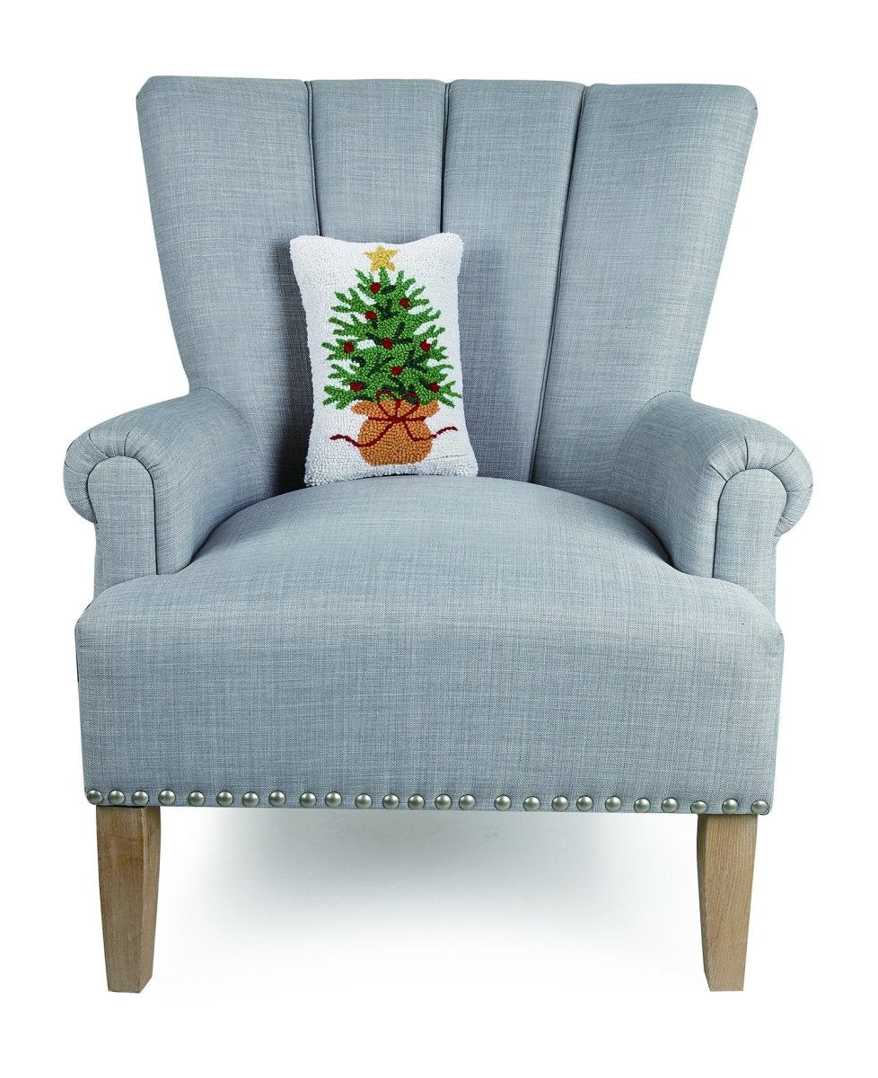 Wrapped Christmas Tree Hooked Wool Throw Pillow on an armchair, showing the throw pillow at room scale, 8x12 inch