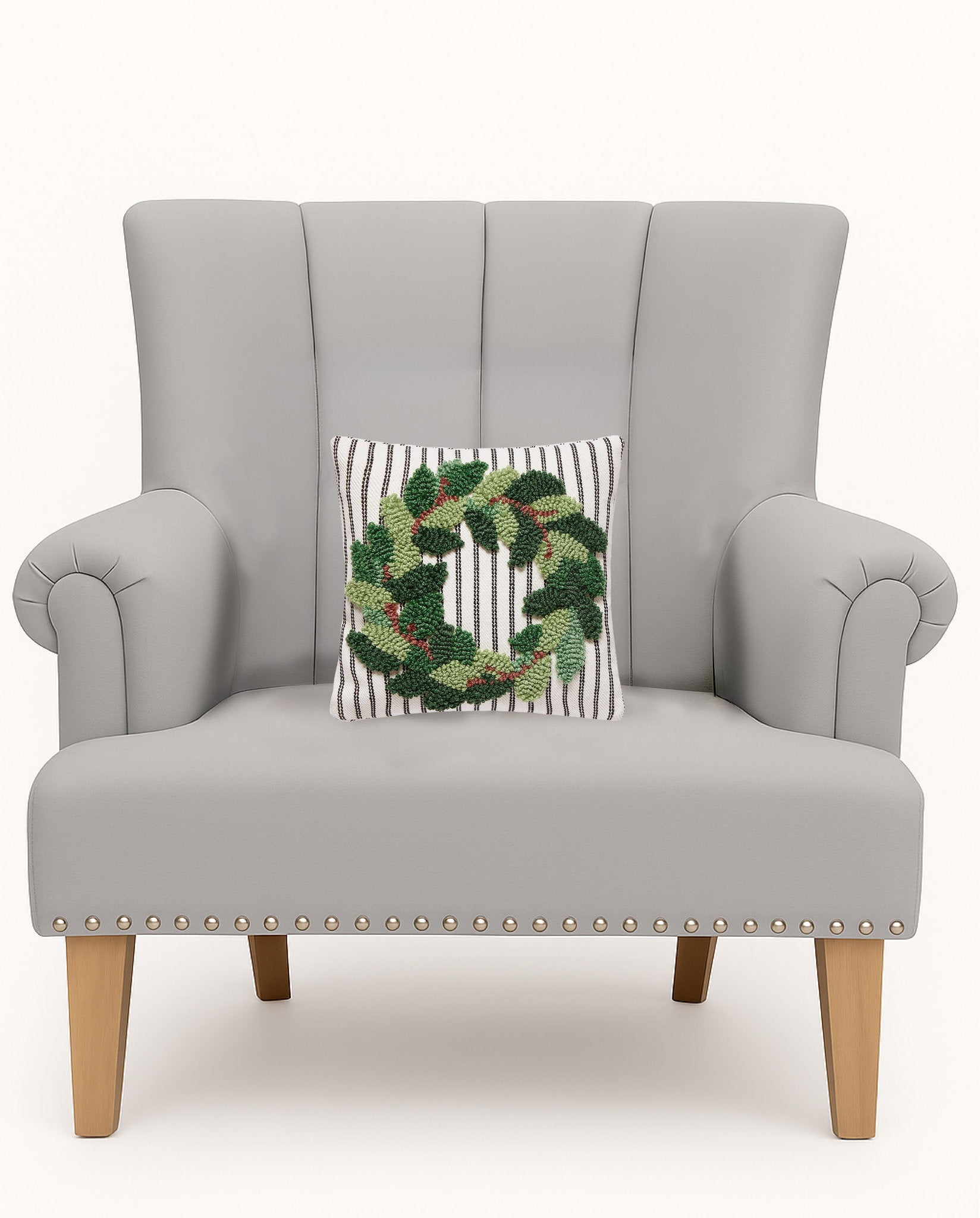 Wreath Tufted Poly Hooked Throw Pillow on an armchair, showing the throw pillow at room scale, 10x10 inch