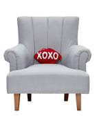 Xoxo Hooked Wool Valentine Throw Pillow on an armchair, showing the throw pillow at room scale, 8x12 inch