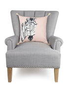 Zebra Embroidered Throw Pillow on an armchair, showing the throw pillow at room scale, 18x18 inch