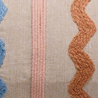Closeup of Zig-Zag Bolster with Poms Embroidered Throw Pillow showing stitch texture and craftsmanship detail